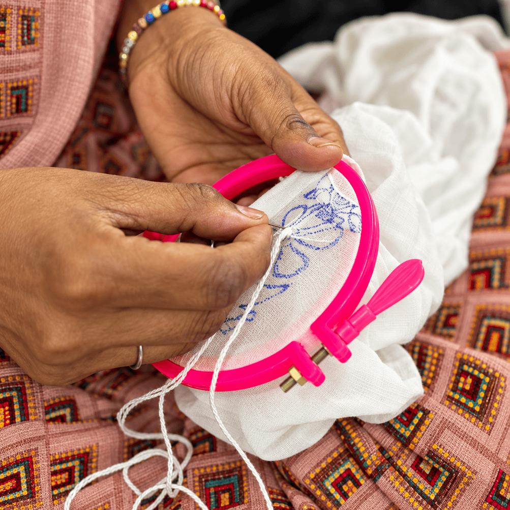 Women Chikankari artisans in Lucknow working by hand to create intricate embroidery patterns using traditional stitching techniques passed down through generations.